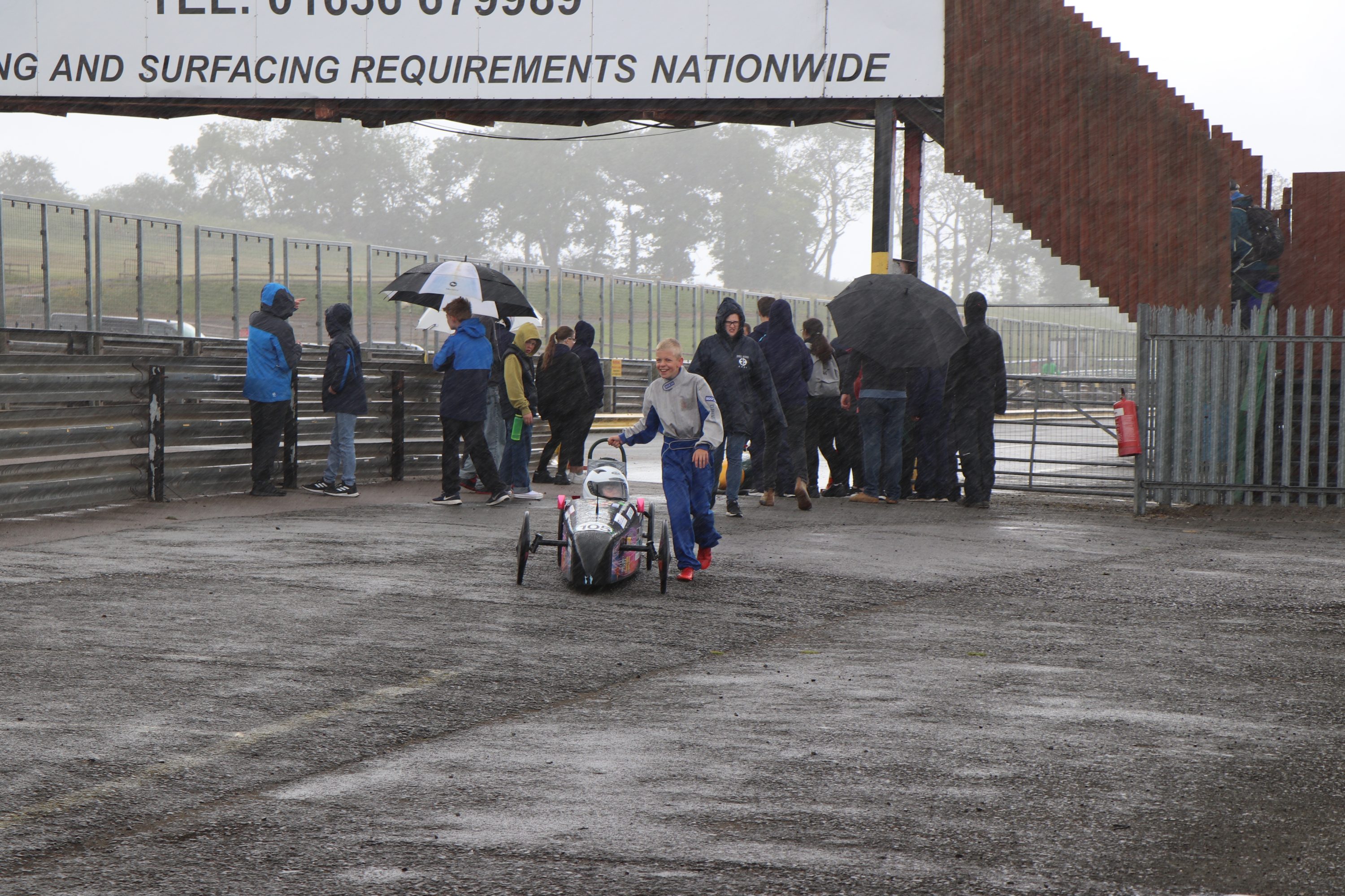 An elated team celebrated as the clouds opened and the rain poured down!