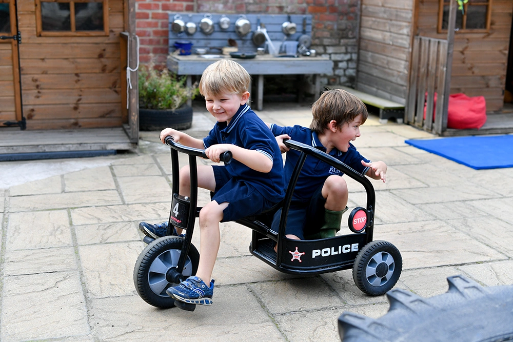 RGS Springfield Wrap Around Care Before School Box RGS Springfield pupils outside playing on tricycle