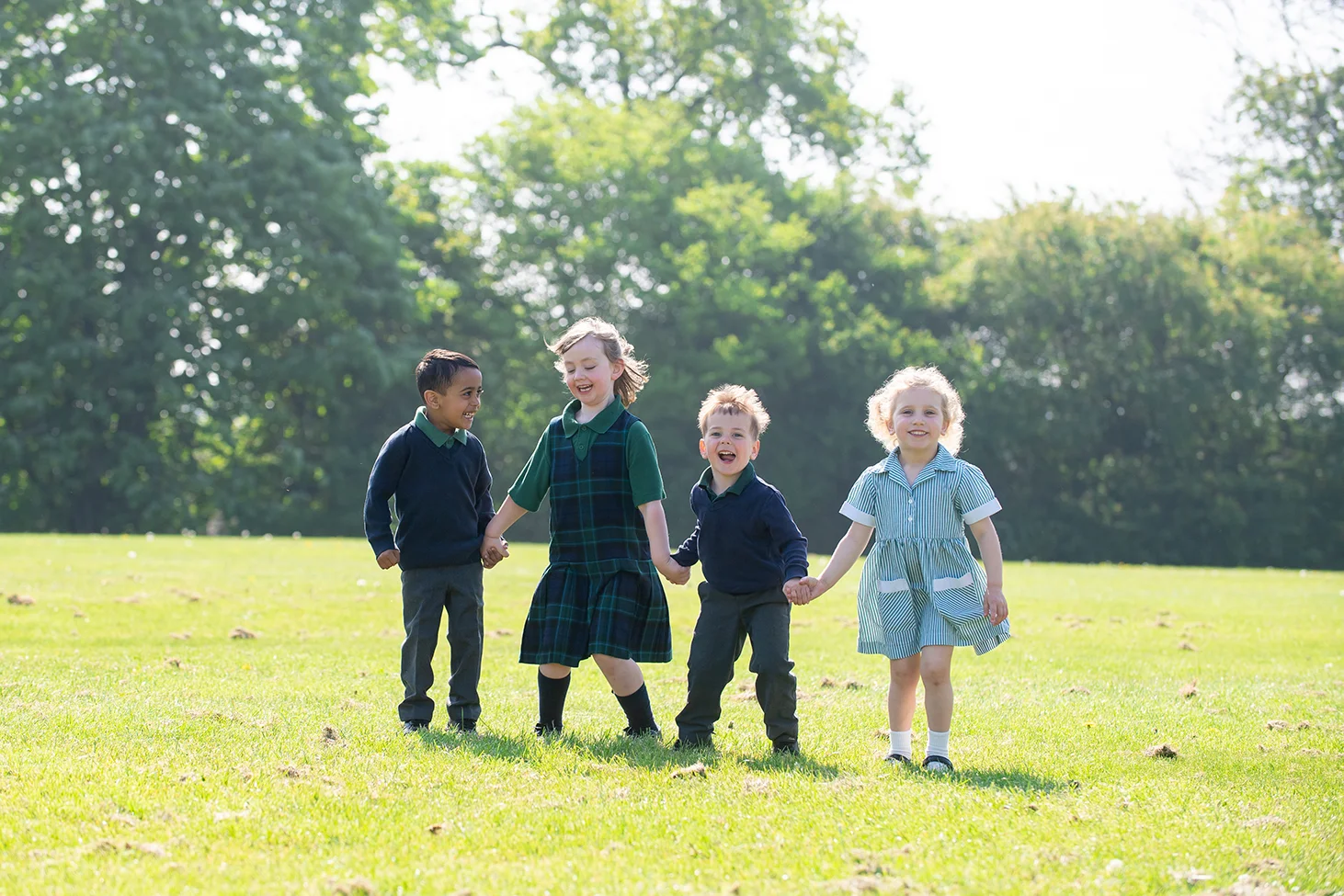 Four children on the field at Dodderhill Nursery